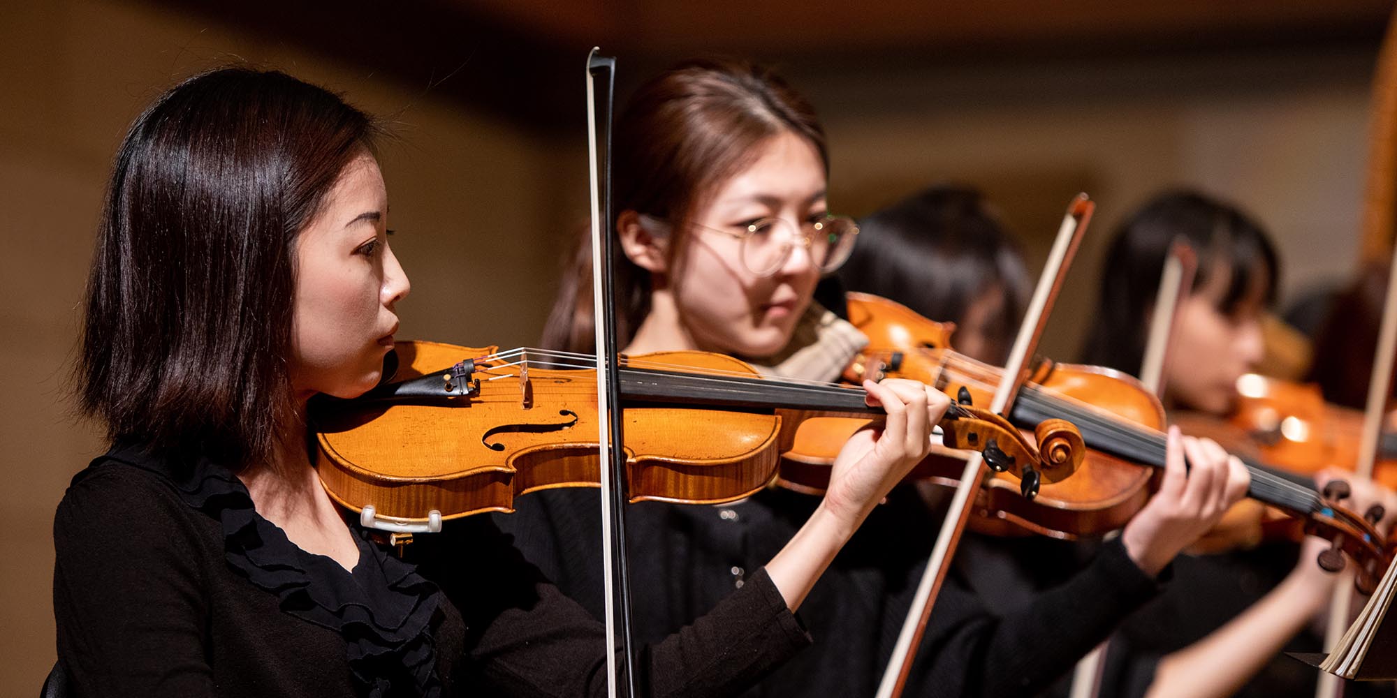 A SFCM student violinist performing with the SFCM orchestra