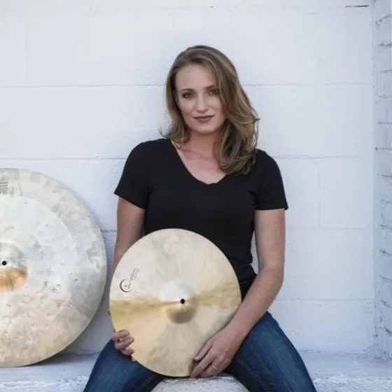 Kristen Klehr headshot while holding cymbal