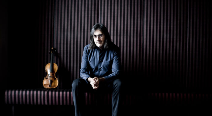 image of Leonidas Kavakos seated next to violin