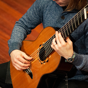 a student playing a guitar close-up