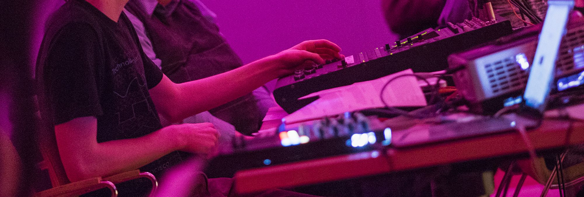 A close up picture of hands on an electronic board