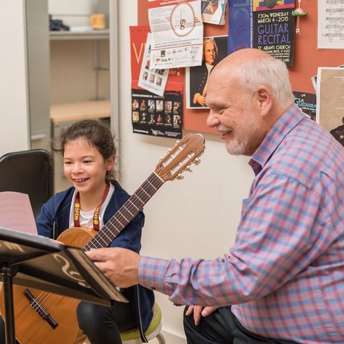 a guitar teacher teaching a private lesson