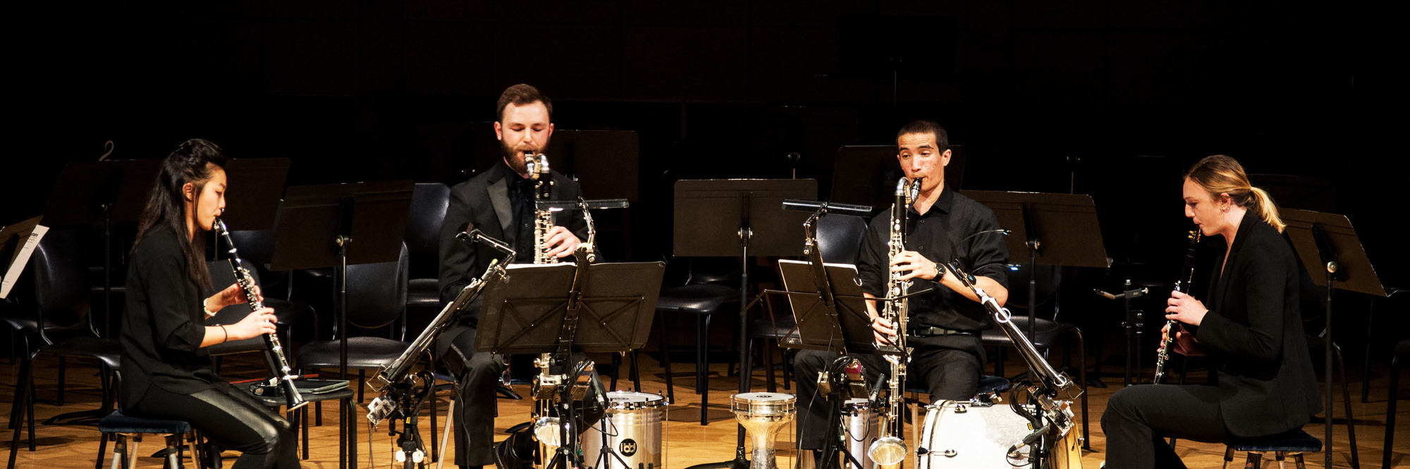 4 clarinet players playing together in a concert