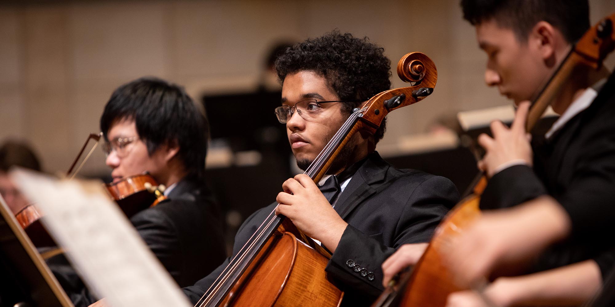A SFCM student performing on the cello in the orchestra