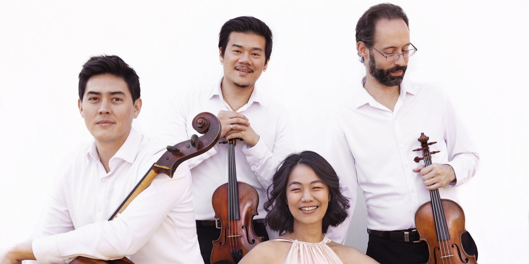 a photoshoot of the Telegraph Quartet holding all of their instruments