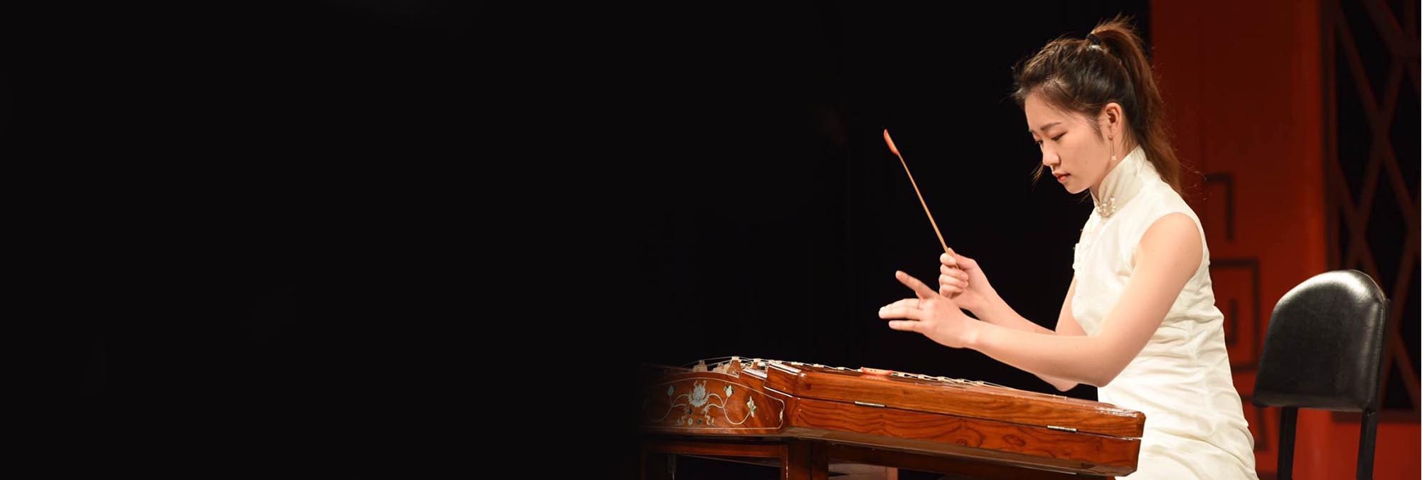 A student from the Shanghai Conservatory performing on a folk instrument