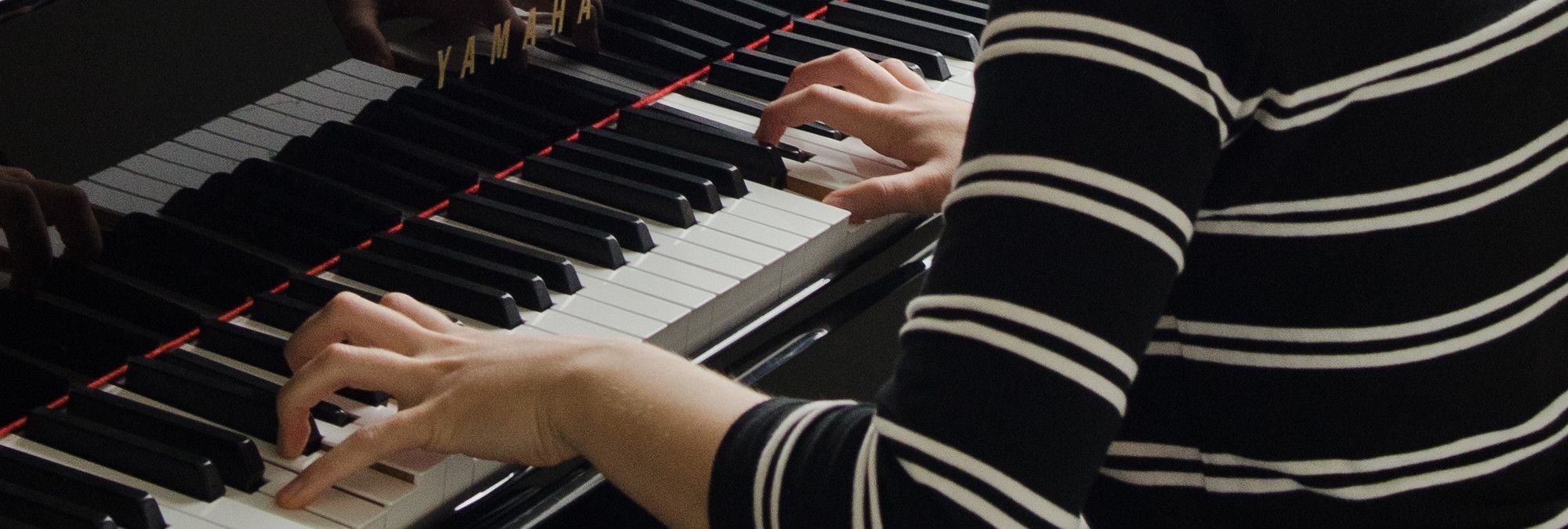 A pianists's hands as they play the piano