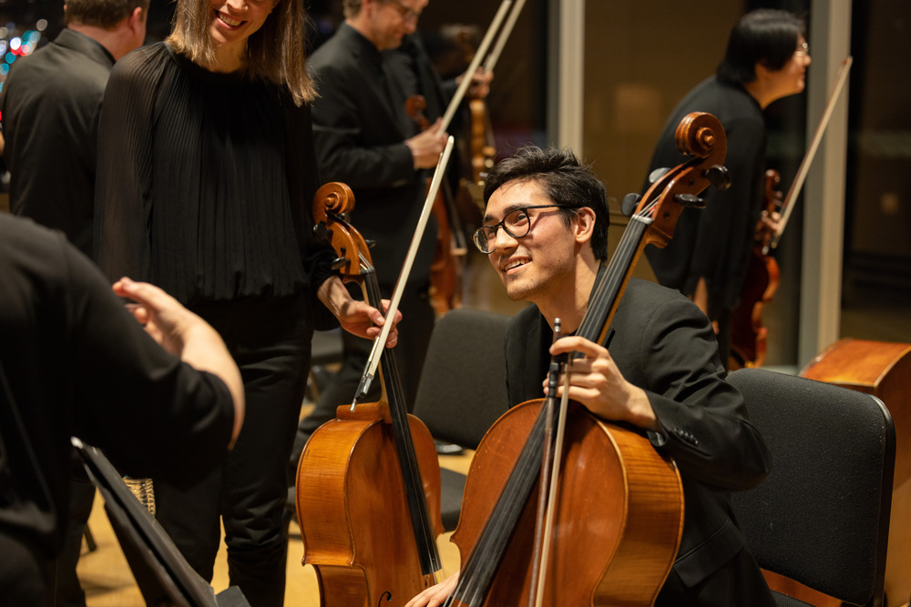 a cello student side by side with the academy