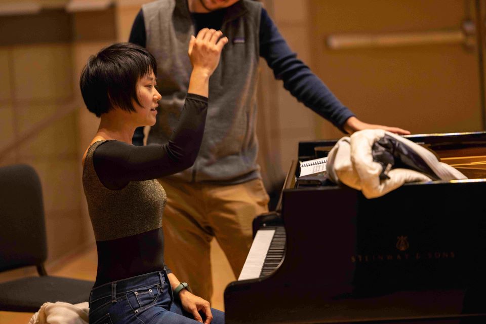 yuja wang talks through a score with a conducting student