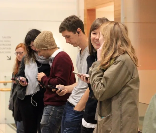 a line of students listening to music through headphones