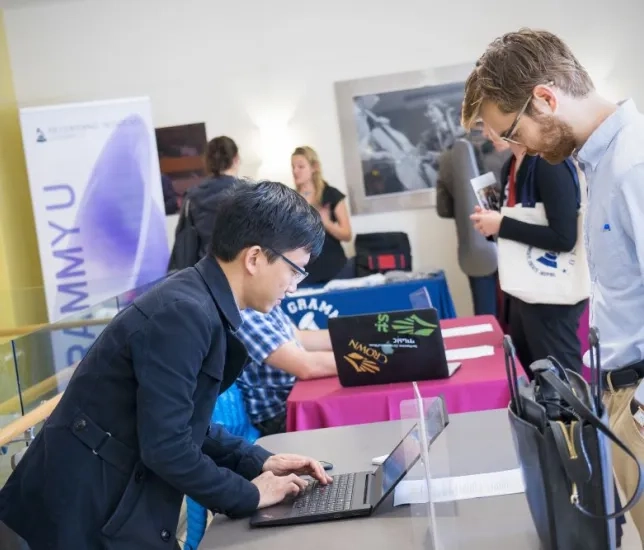 a student leans over a table at a job fair