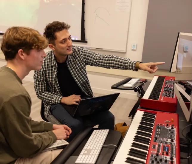 Rafe Axne (left) and Theo Popov (right) work in an SFCM studio.