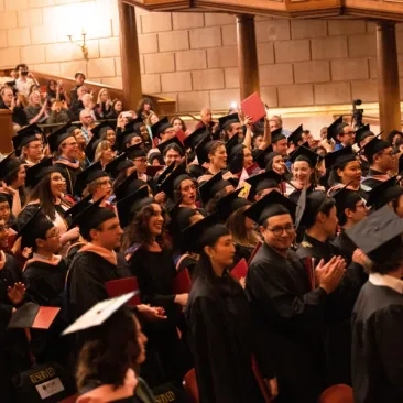 students in their caps and gowns in the auditorium
