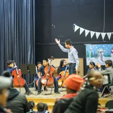 a teacher works with young students on stage