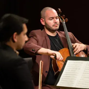 A cellist plays expressively in a chamber group