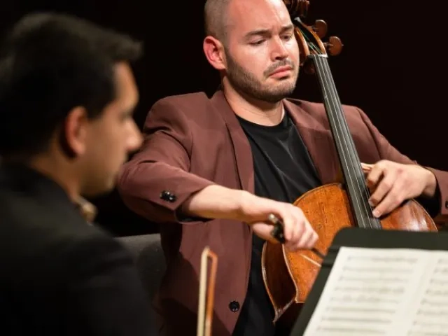 A cellist plays expressively in a chamber group
