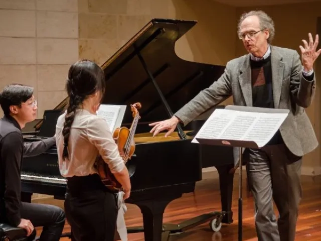 Tim Bach teaching a violinist and pianist