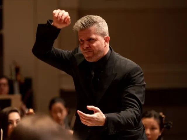 edwin outwater conducting during a performance, he is about to give a strong downbeat