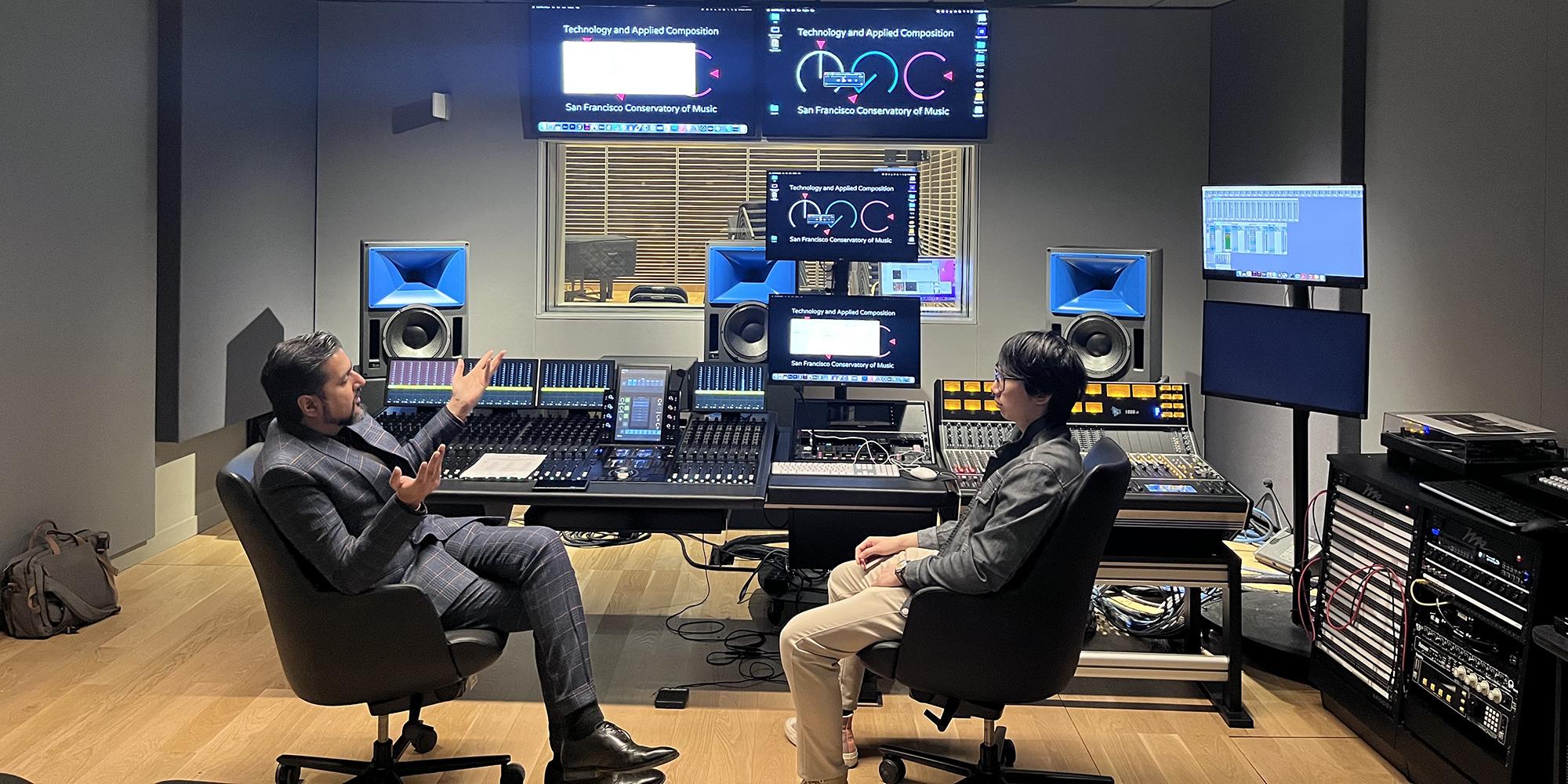 composer ricky kej talks to a student in studio h