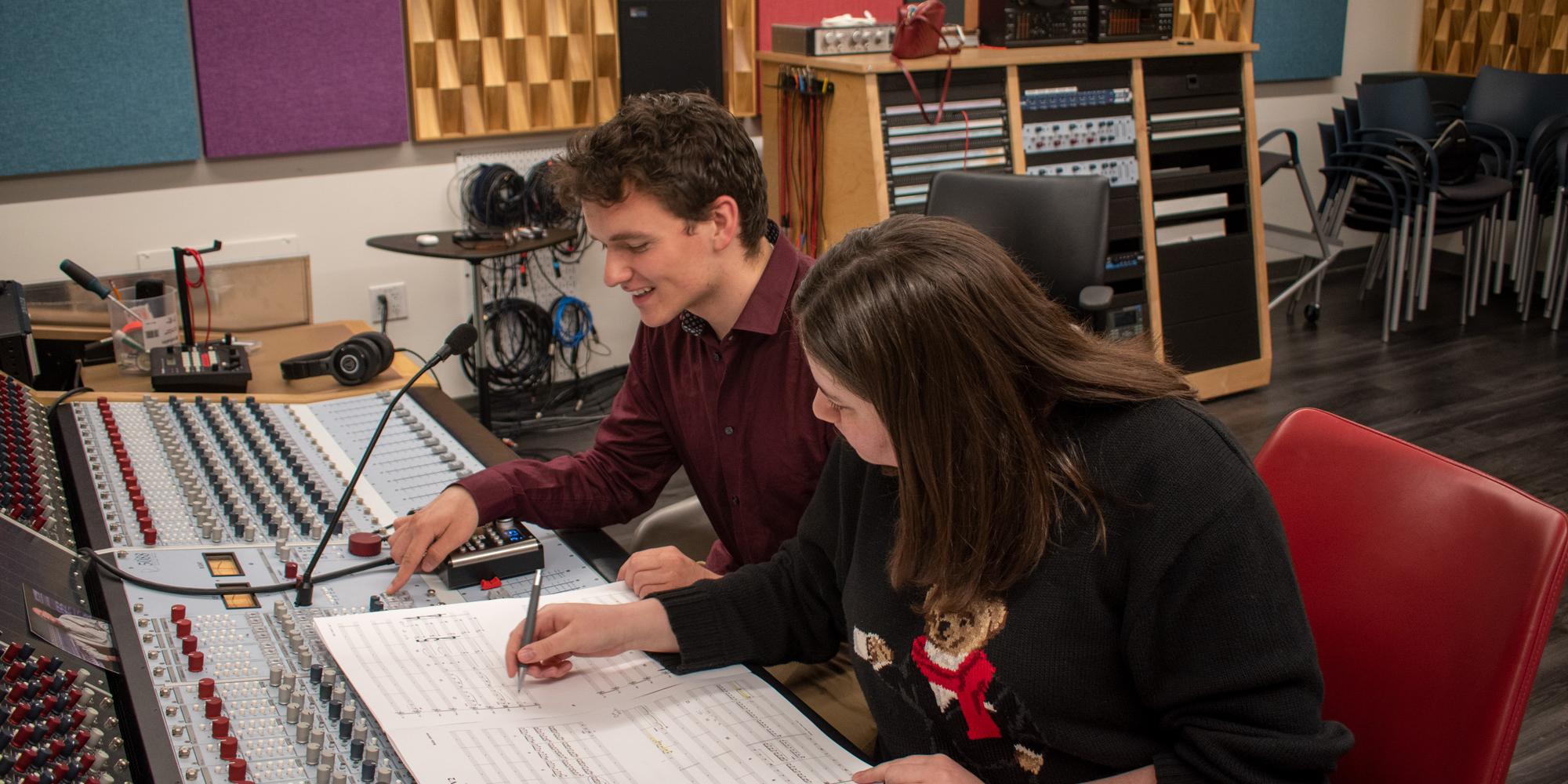 two students look over a film score in a SFCM TAC studio