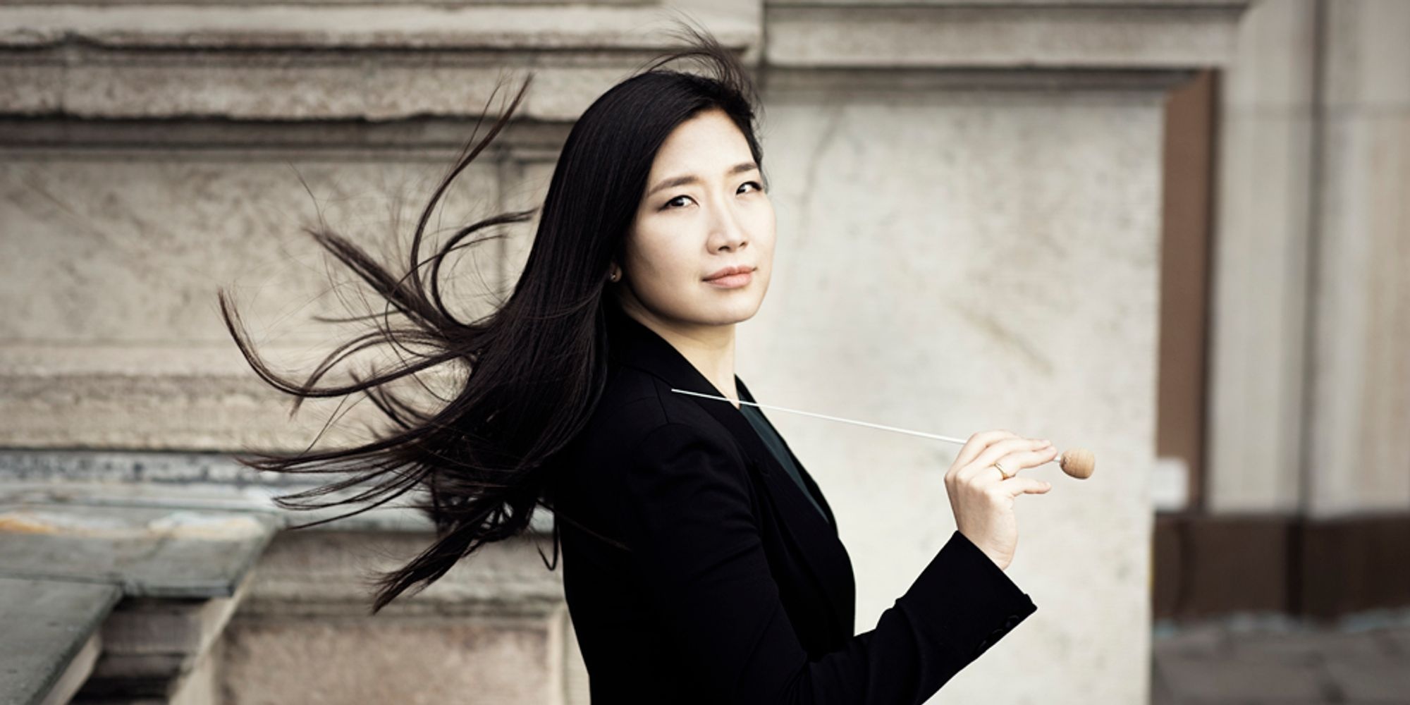 Eun Sun Kim outside with conducting baton