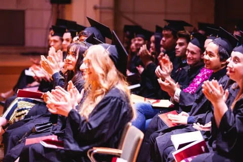 2019 commencement graduates applauding