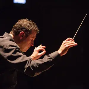 Curt Pajer conducting an opera in the dark