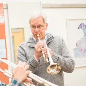 David Burkhart headshot playing trumpet