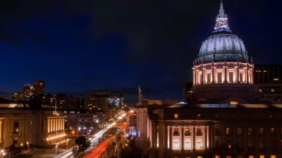a night shot of city hall and Herbst theater from the Bowes building