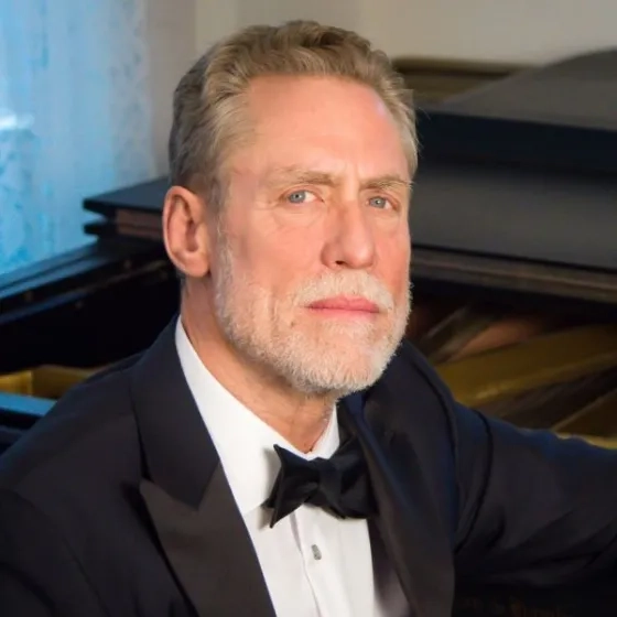 David Garner headshot at the piano