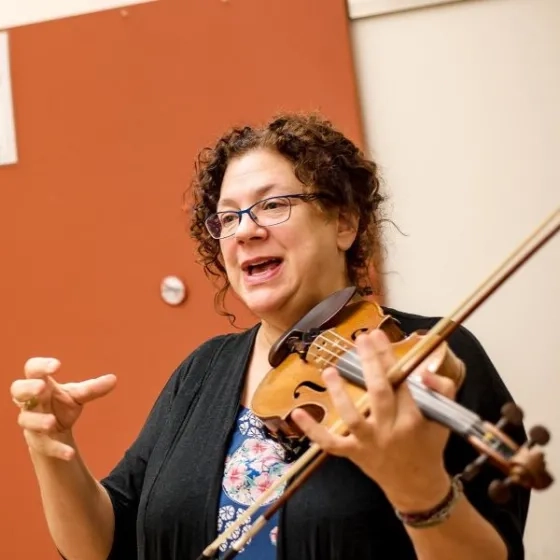 Kay Stern teaching while holding violin