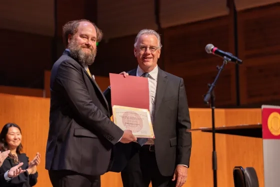 Dean Jonas Wright presents Paul Welcomer with the Sarlo Award.