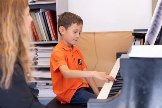 Tioma, 8, practices the piano at SFCM.