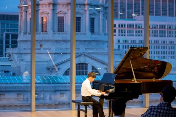 A Pre-College student plays piano in the Bowes Center.