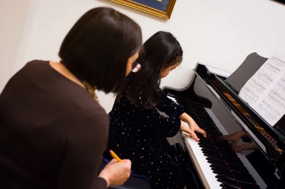 Student works with music teacher.