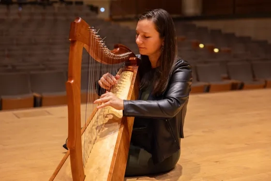 Jennifer Ellis plays a harp she built in high school.