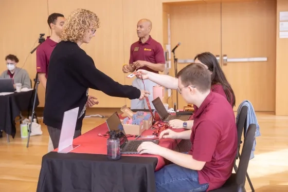 A students checks into the Bowes Center.