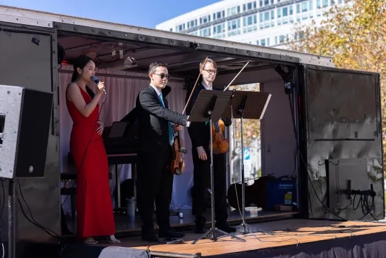 The Concert Truck musicians Susan Zhang and Kenneth Renshaw with student Aleksi Zaretsky.