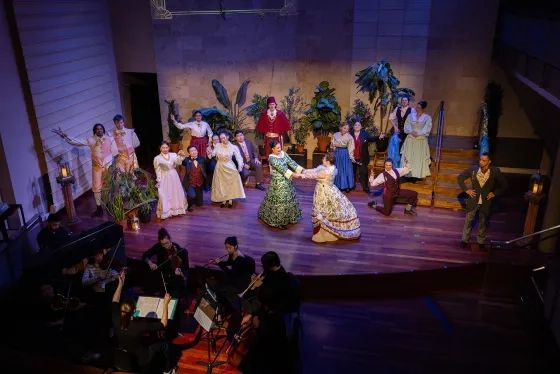 The ensemble cast performs with orchestra students.