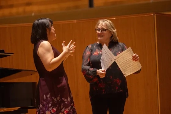 Pat Racette works with students in the Caroline H. Hume Concert Hall. 