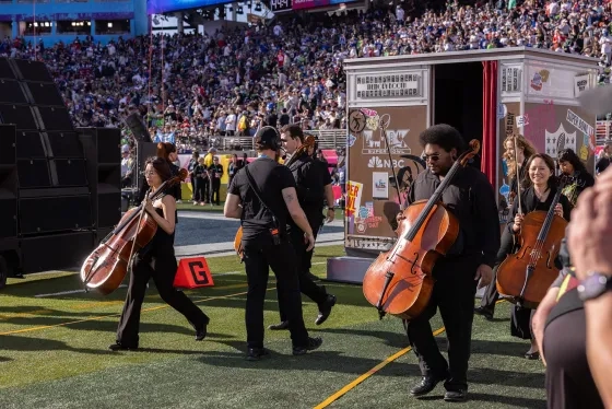 Students enter the field ahead of the performance.
