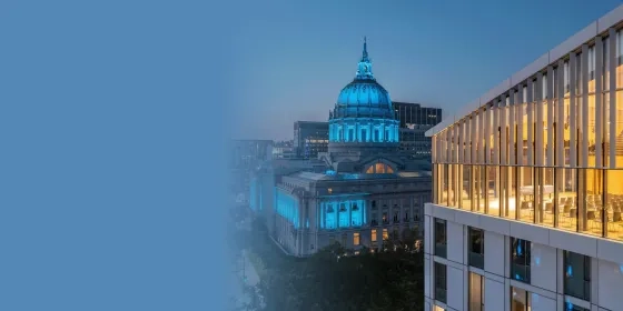 Bowes Center at dusk, with San Francisco City Hall in the background