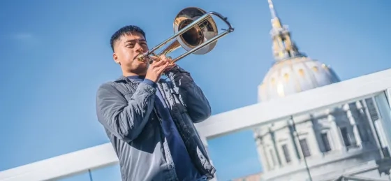 SFCM student playing trombone in front of City Hall