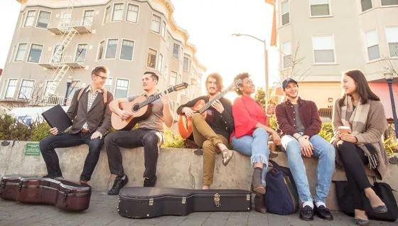 Students guitarists posing for evening photo in Patricia Green park Octavia St