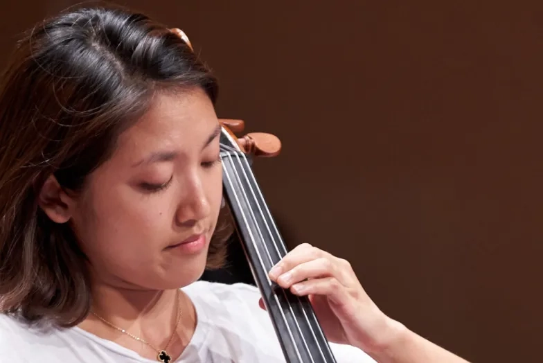 Student playing a cello