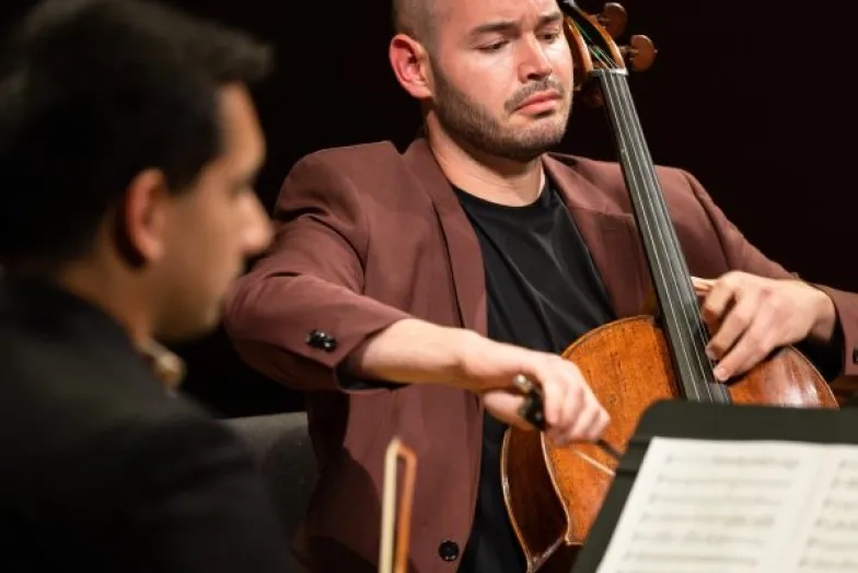 A cellist plays expressively in a chamber group