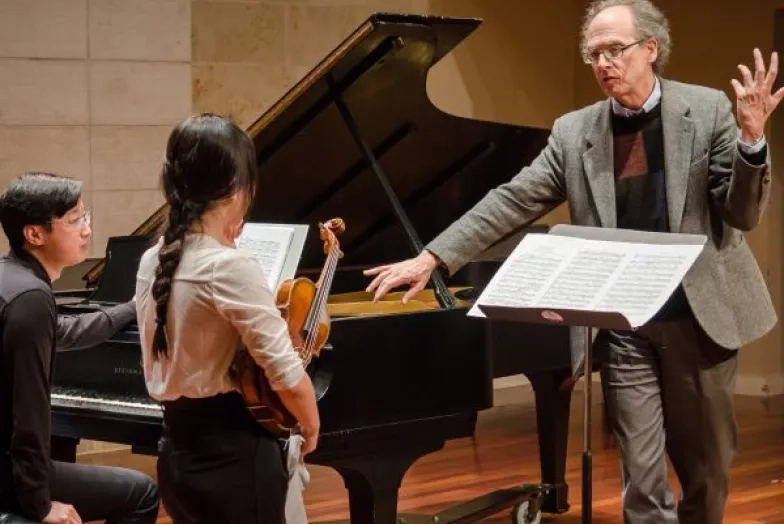 Tim Bach teaching a violinist and pianist