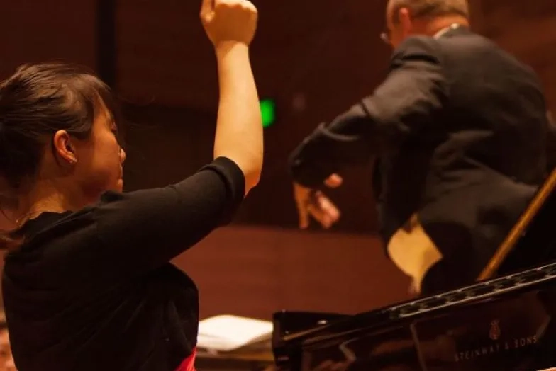 a pianist performs a concerto with the orchestra