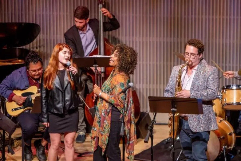 students perform with teachers in a jazz ensemble