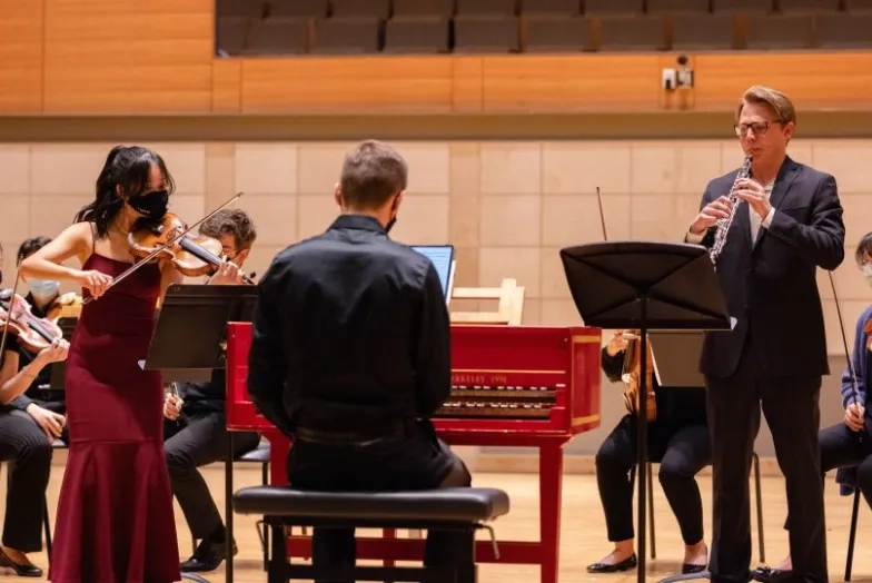 an oboist and a violinist perform a concerto together for a winter term project